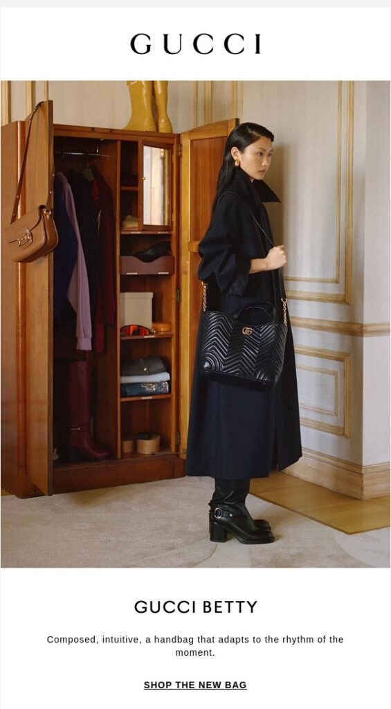 An email from Gucci showing a woman in a black coat carrying a black Gucci handbag. This serves as an aspirational product example for an online retailer’s campaign on World Dream Day.